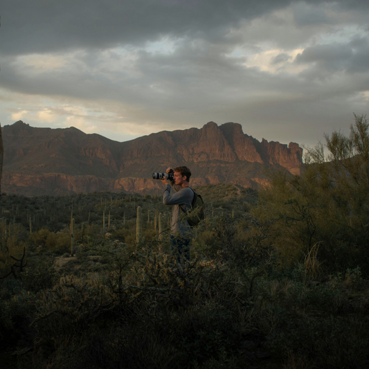 Man Photographing in the Desert Landscape with overcast skies