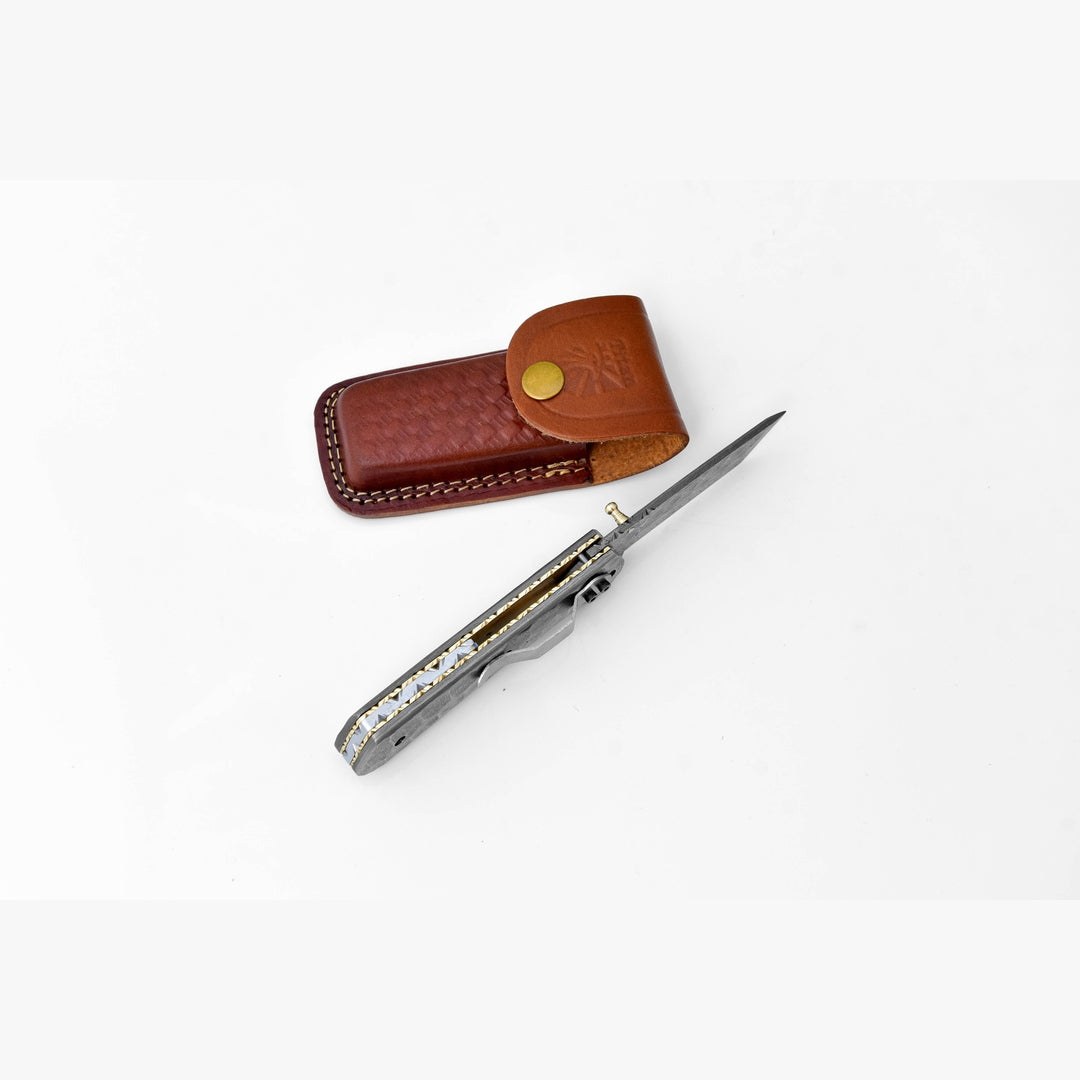 Folding knife with leather sheath on a white background