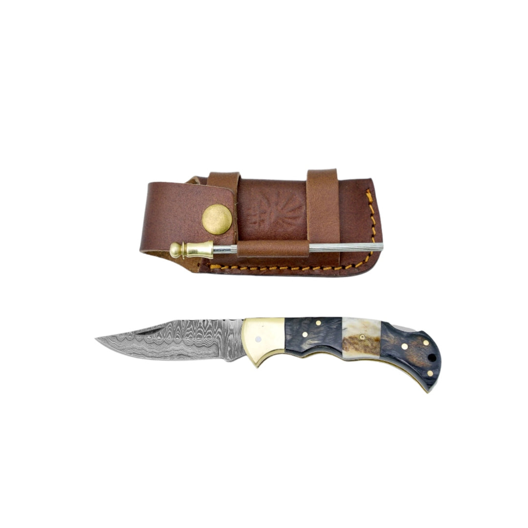 Knife with gold accents and leather sheath on a white background