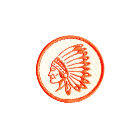 Circular patch with a profile of a person wearing an headdress on a white background