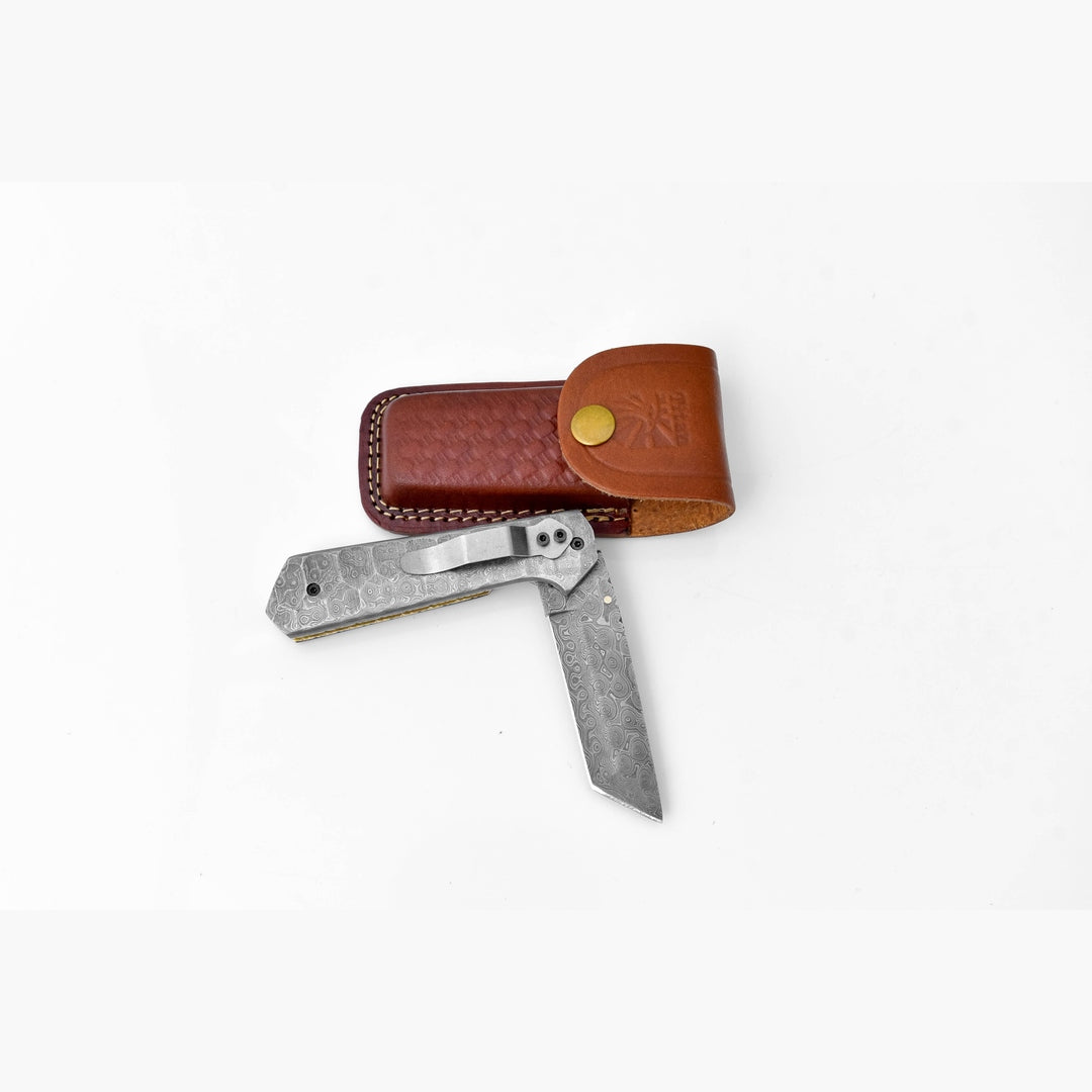 Pocket knife with leather sheath on a white background