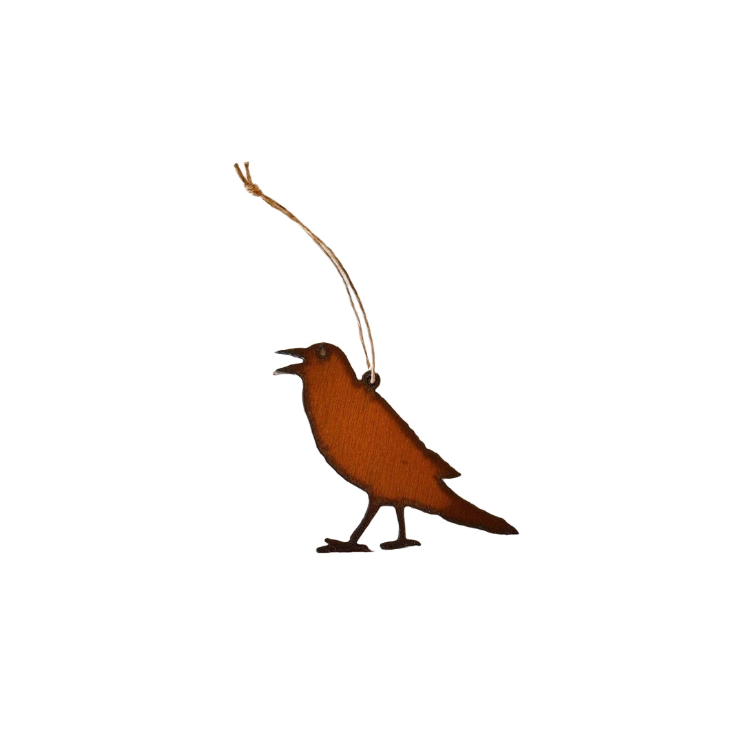 A steel raven ornament on a white background.