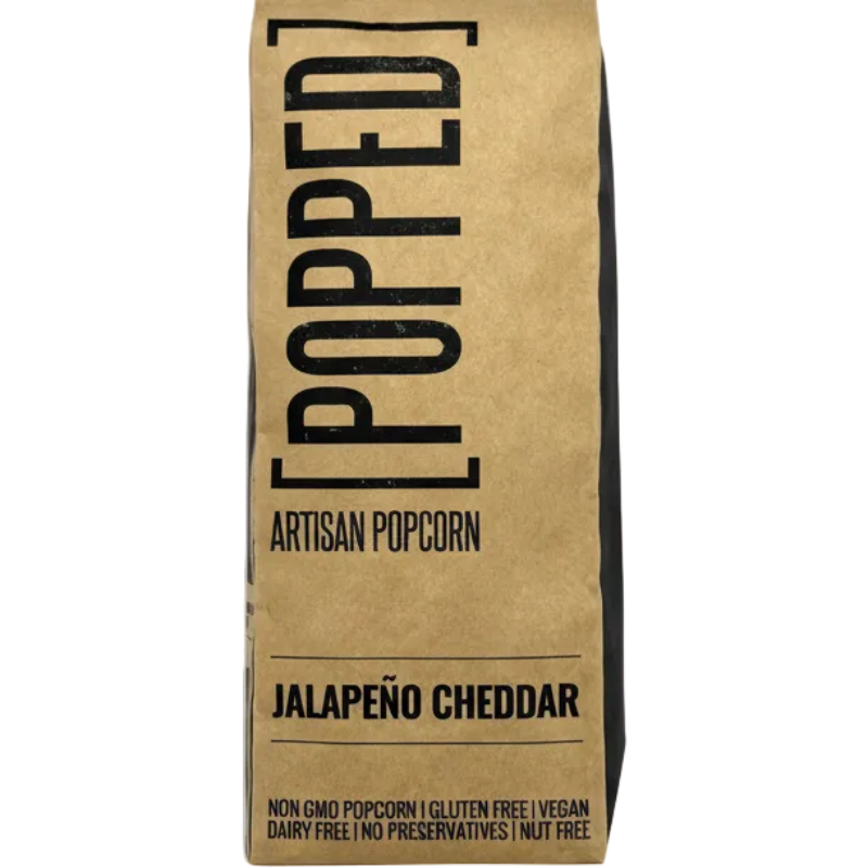 Kraft paper bag with 'Popped' branding and jalapeño cheddar flavor text on a white background